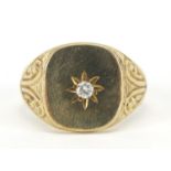 Unmarked gold diamond signet ring with engraved shoulders, the diamond approximately 2.4mm in