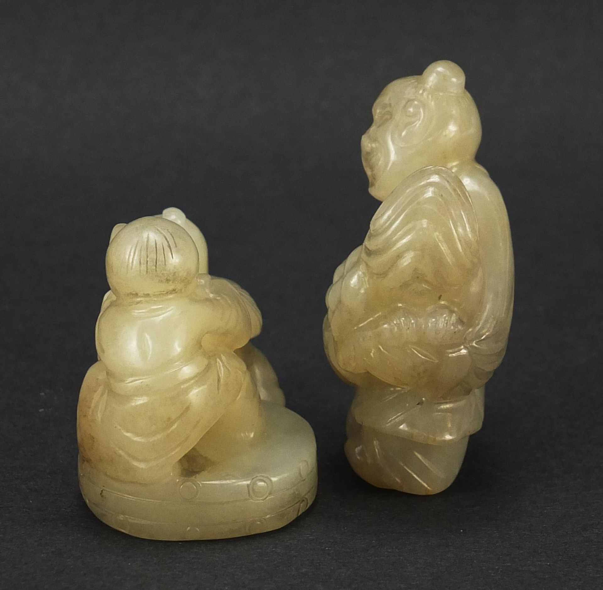 Two Chinese celadon and russet jade carvings including one of a figure holding fruit, the largest - Image 3 of 7
