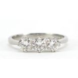 White gold diamond three stone ring, the central diamond approximately 4.5mm in diameter, indistinct