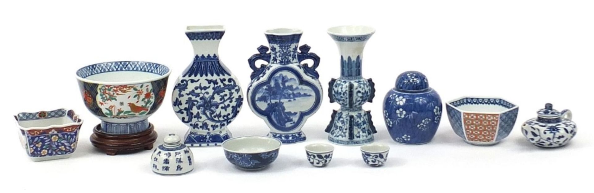 Chinese and Japanese porcelain including archaic style vase and bowl on hardwood stand, the