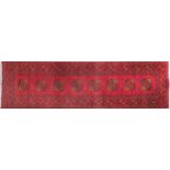 Rectangular Persian carpet runner having an all over floral design with red grounds, 390cm x