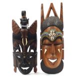 Two African hardwood carved hardwood face masks with beadwork inlay, the largest 46cm high : For