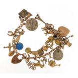 9ct gold charm bracelet with a selection of gold and metal charms including watering can, hand of