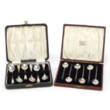 Two sets of six silver teaspoons and coffee bean spoons housed in velvet and silk lined fitted