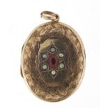 Oval gold coloured metal garnet and seed pearl locket, 3.5cm high, 5.1g : For Further Condition