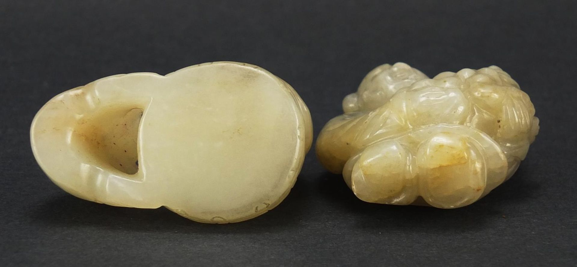 Two Chinese celadon and russet jade carvings including one of a figure holding fruit, the largest - Image 7 of 7