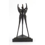 Modernist patinated bronze study of three figures raised on a triangular marble base, 24cm high :