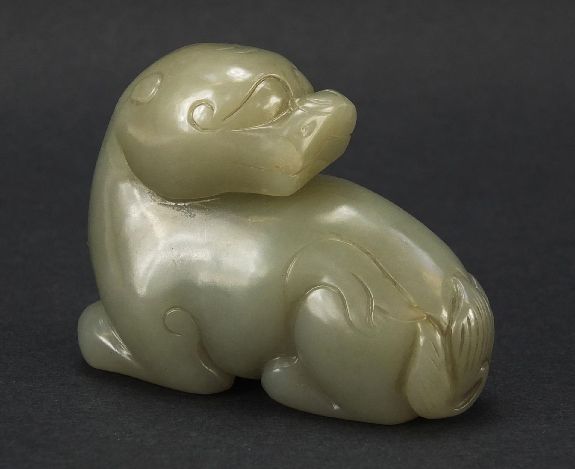 Chinese celadon and russet jade carving of a mythical animal, 6cm in length : For Further