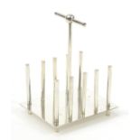 Modernist silver plated four slice toast rack in the manner of Christopher Dresser, 15cm high :