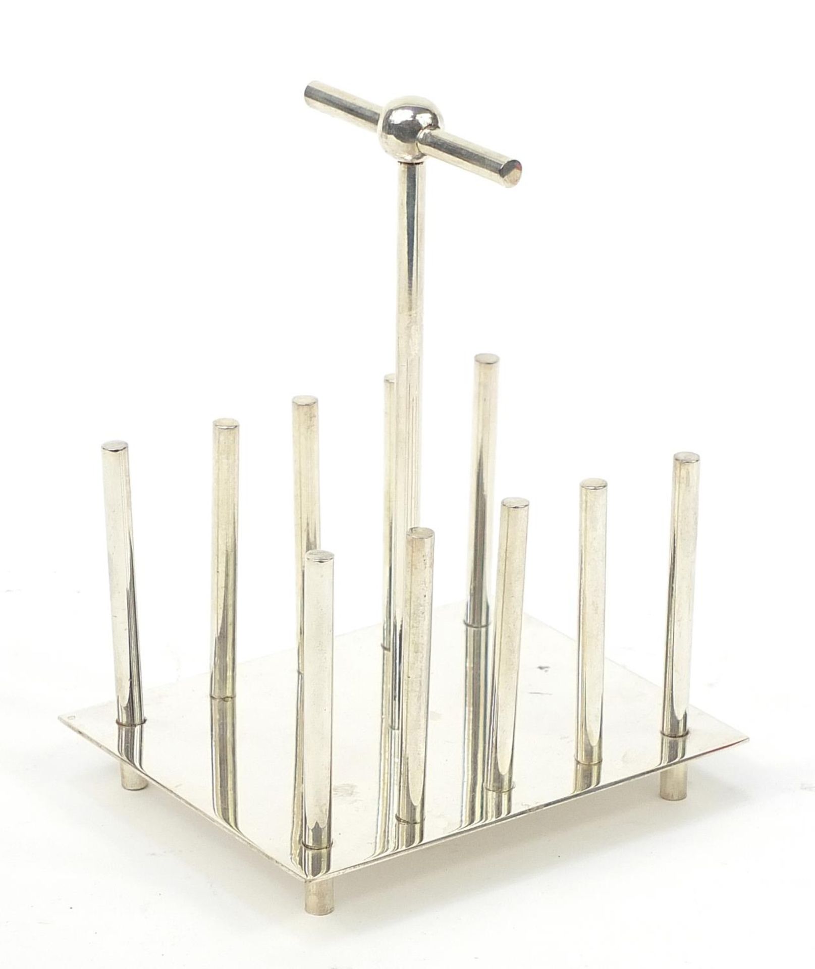 Modernist silver plated four slice toast rack in the manner of Christopher Dresser, 15cm high :