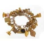 Good 9ct gold charm bracelet with a large selection of mostly gold charms including agate love heart