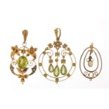 Three Art Nouveau gold pendants set with peridot, seed pearls and opal, the largest 4.4cm high,