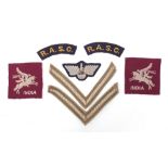 Seven British military World War II cloth badges including pair of RASC Titles, pair of rank strips,