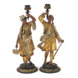 Pair of cold painted spelter figural candlesticks of Middle Eastern figures wearing traditional