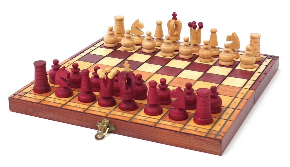 Carved wood half stained chess set with fitted folding chess board, the largest pieces each 6.5cm