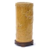 Chinese yellow monochrome porcelain cylindrical vase decorated in relief raised on a carved hardwood