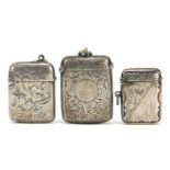 Three Victorian and later silver vestas with engraved decoration, Chester 1899, Birmingham 1898