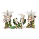 Pair of 19th century Continental porcelain three section floral encrusted vases with Putti and a