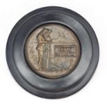 Military interest bronzed plaque with ebonised frame, 13cm in diameter : For Further Condition