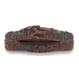 Antique coquilla nut snuff box carved with figure and dog beside a tree and an Irish rose, 10cm wide