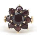Large 9ct gold garnet flower head ring, the head 1.6cm in diameter, size N, 4.6g : For Further