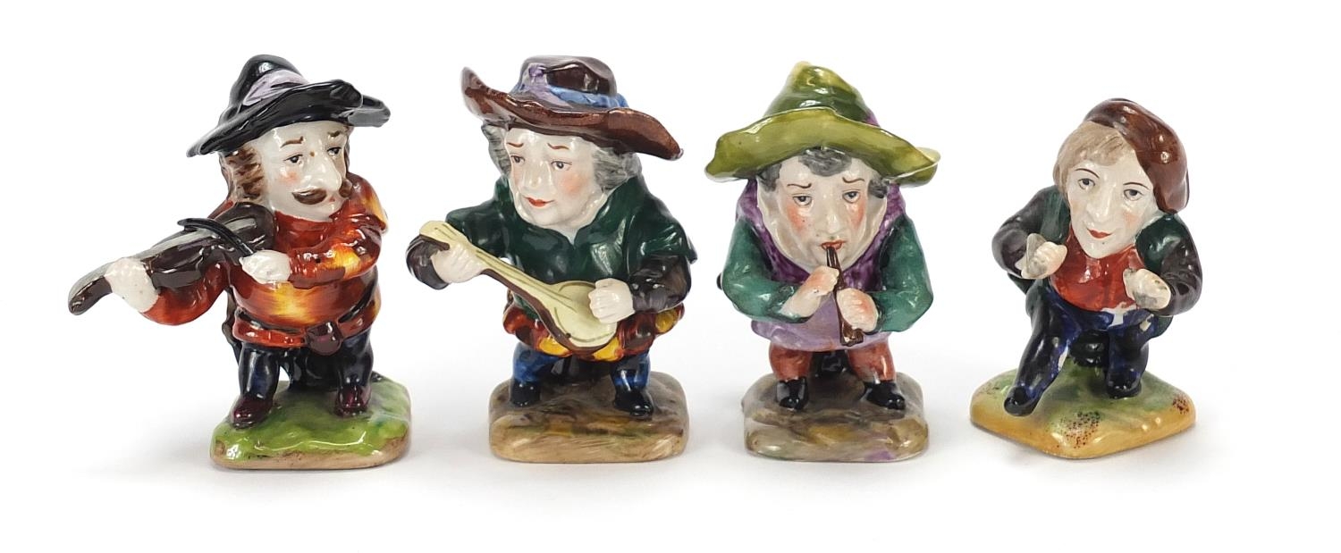 Four Crown Derby style hand painted porcelain dwarf musicians, the largest 9cm high : For Further