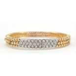 14ct gold diamond three row hinged bangle, set wit thirty three diamonds, the diamonds approximately