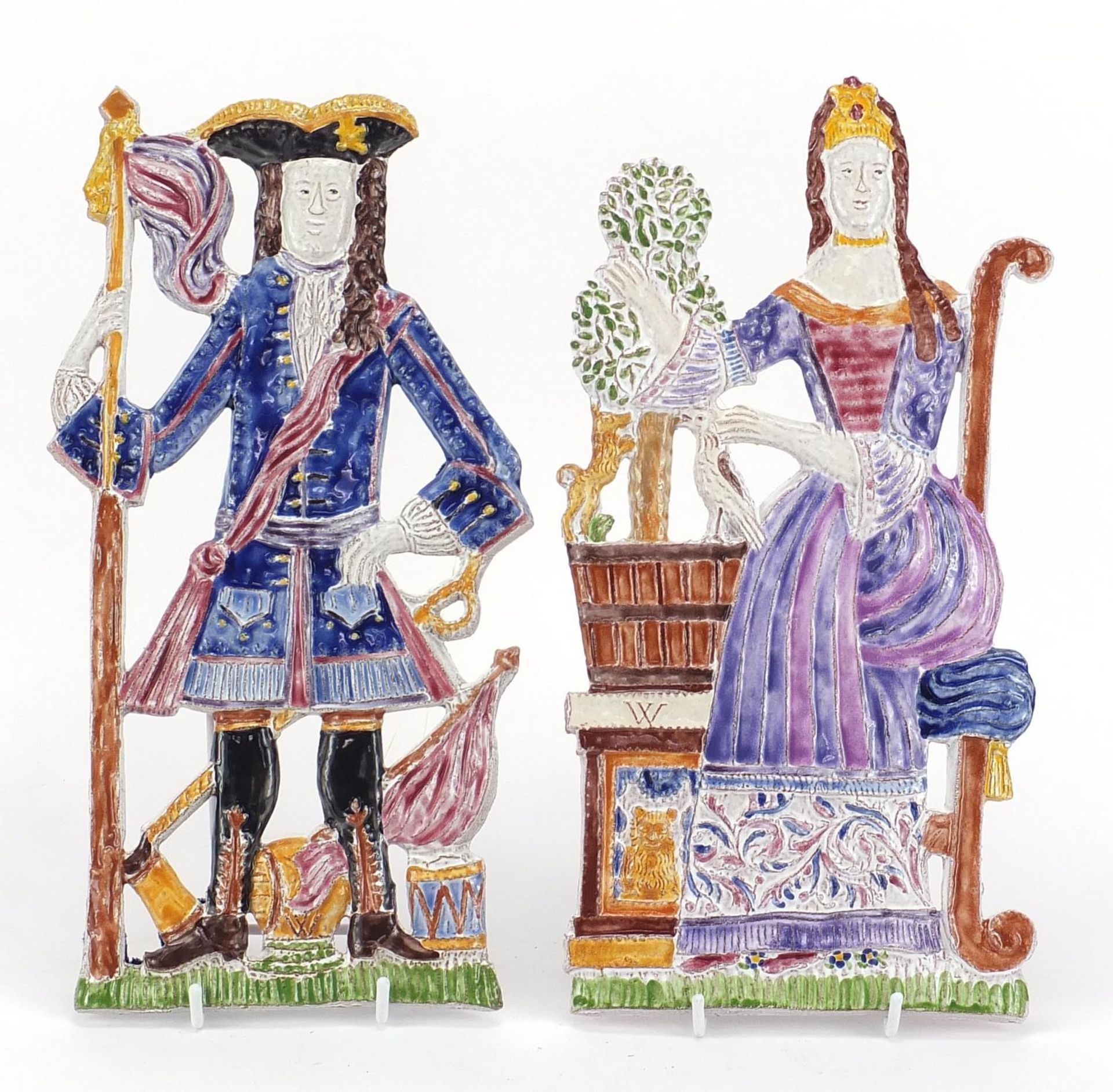 Paleis Het Loo, Two Dutch ceramic wall plaques of figures in traditional dress, the largest 36cm