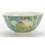 Chinese porcelain bowl hand painted in the famille rose palette with figures in a palace setting,