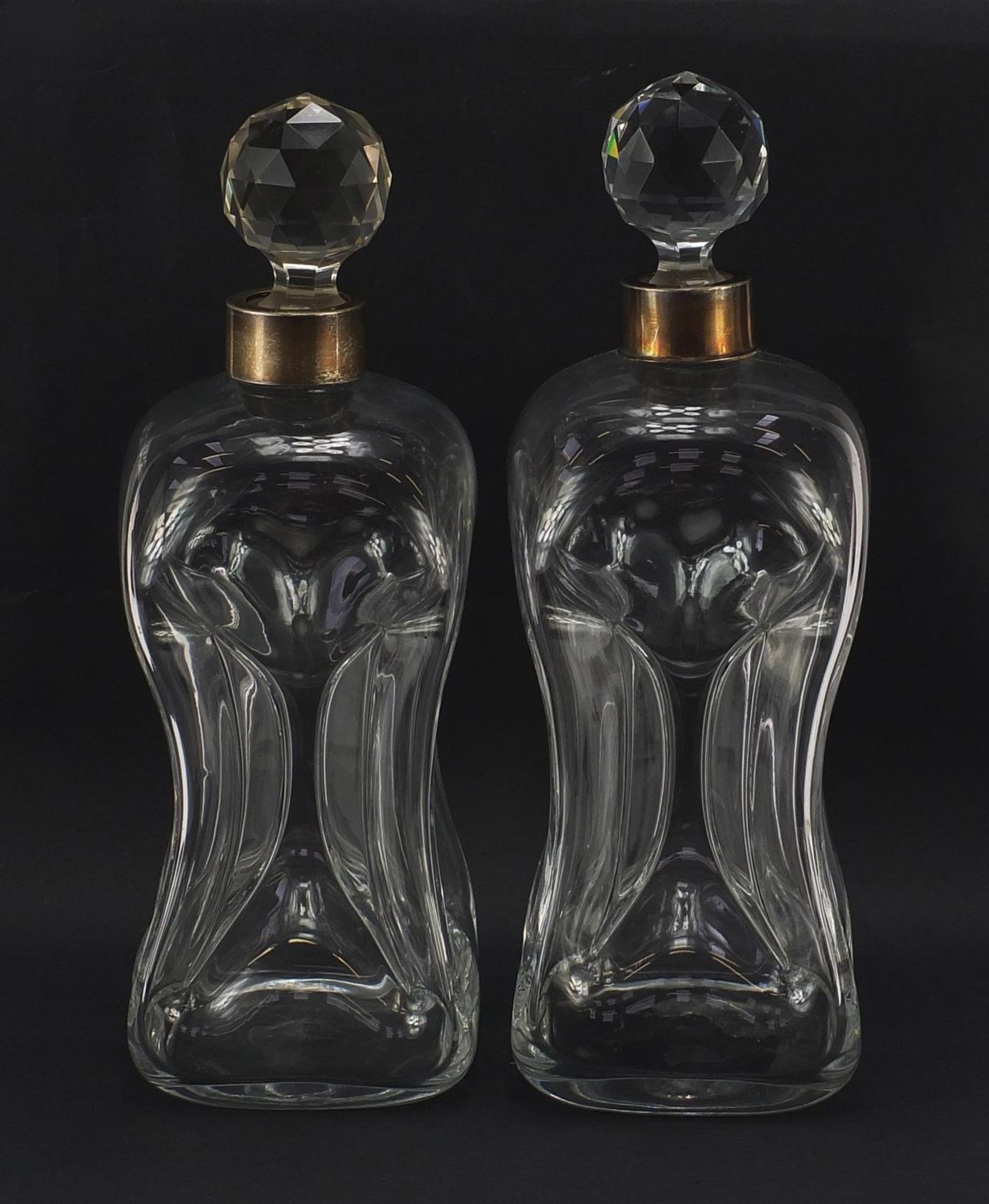 Matched pair of hour glass decanters including one with silver collar by Elkington & Co, each 28cm