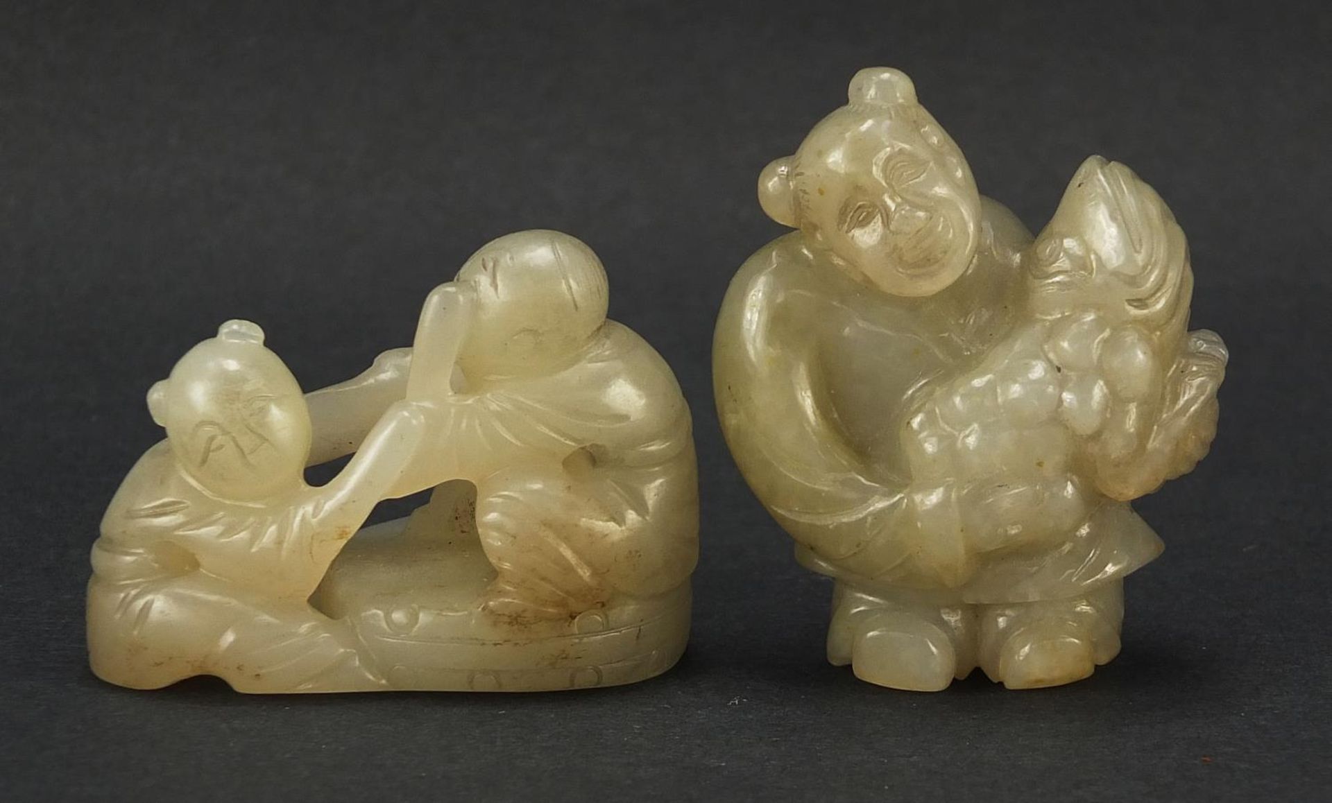 Two Chinese celadon and russet jade carvings including one of a figure holding fruit, the largest - Image 2 of 7