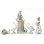 Nao and Lladro figures including girl feeding geese and a girl with a basket of oranges, the largest