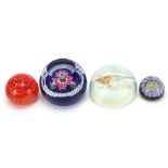 Four colourful glass paperweights including Caithness, Whitefriars Anemone and an opalescent bird