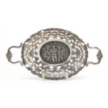 Continental oval pierced silver coloured metal twin handled bonbon dish embossed with cavaliers,