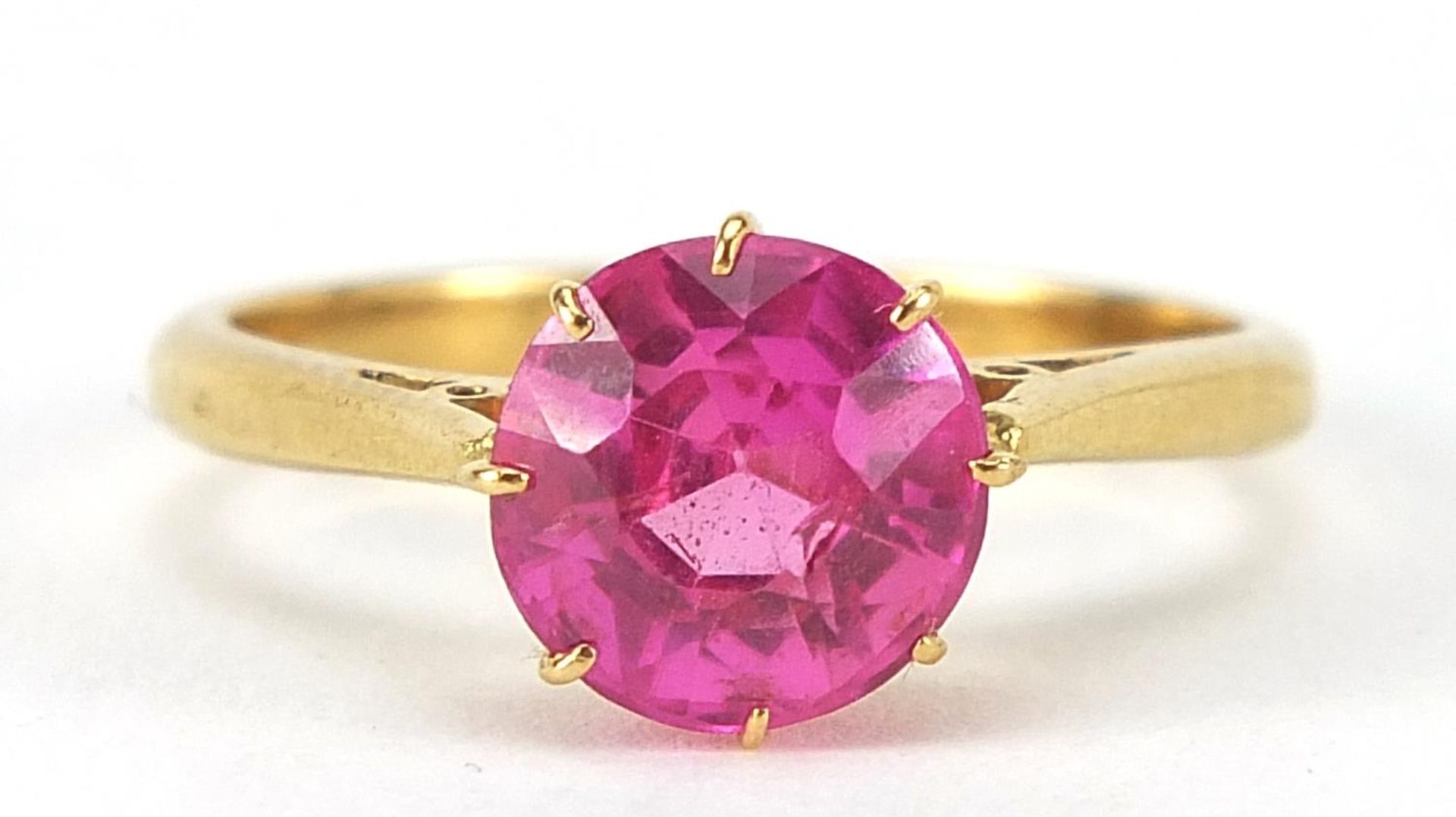 18ct gold ruby solitaire ring, the stone approximately 8mm in diameter, size N, 3.7g : For Further