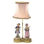 Ornate gilt brass table lamp surmounted with two porcelain musicians, 45cm high : For Further