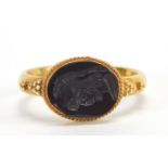 Antique unmarked gold intaglio seal ring carved with a gladiator head, (tests as 15ct+ gold) size Q,