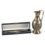 Silver coloured metal replica of the Legendary Facon Gaucho and silver coloured metal jug, the