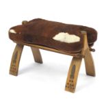 Antique wooden camel stool with animal hide cushion, 55cm wide : For Further Condition Reports