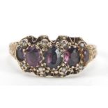 Victorian 9ct gold amethyst and seed pearl ring with ornate setting and chased band, housed in an M.