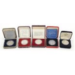 Five commemorative silver medals with fitted cases including examples commemorating Queen
