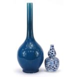 Two Chinese porcelain vases including a blue and white double gourd example hand painted with two
