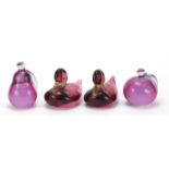 Four Murano glass paperweights comprising two gold flecked ducks and two of fruit with paper labels,