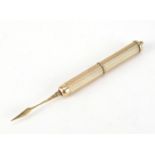 9ct gold engine turned propelling toothpick by Cohen & Charles, Birmingham 1991, 7.6cm in length