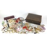 Vintage and later costume jewellery arranged in a tooled leather jewellery box including bangle,