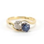 18ct gold diamond and sapphire crossover ring, the diamond approximately 4mm in diameter, size K,