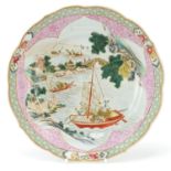 Chinese porcelain plate finely hand painted in the famille rose palette with figures in junks in a