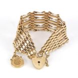9ct gold eight row gate bracelet with love heart padlock and America 1945 dos peso gold coin
