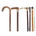 Four walking sticks and a Hardy fishing stick including a bamboo example concealing a part fishing