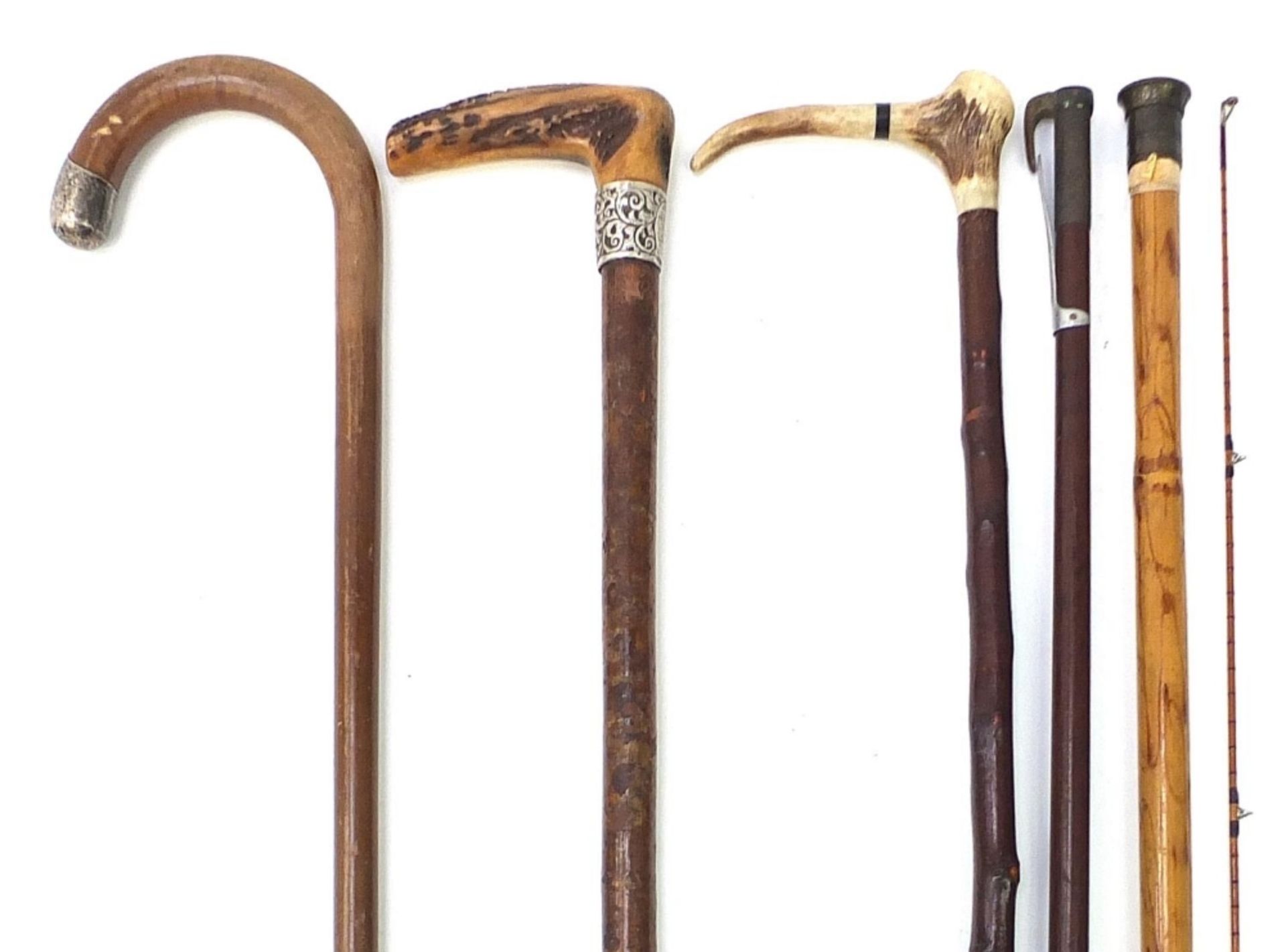 Four walking sticks and a Hardy fishing stick including a bamboo example concealing a part fishing